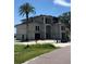 Two-story building with a barrel tile roof, and large arched entryway on sandy lot at 15805 Redington Dr, Redington Beach, FL 33708