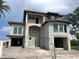 Spacious modern home exterior featuring large window openings and a barrel tile roof at 15805 Redington Dr, Redington Beach, FL 33708