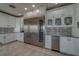 Modern kitchen featuring white cabinets, stainless steel appliances, and a tile backsplash design at 15805 Redington Dr, Redington Beach, FL 33708