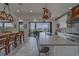 Spacious open kitchen, dining area with an island, stainless appliances, and water views at 15805 Redington Dr, Redington Beach, FL 33708