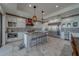 Spacious gourmet kitchen featuring white cabinetry, patterned backsplash, and stainless steel appliances at 15805 Redington Dr, Redington Beach, FL 33708
