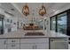 Open-concept kitchen featuring stone countertops, island seating, and stainless steel appliances at 15805 Redington Dr, Redington Beach, FL 33708