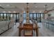 Bright living room with plush seating, entertainment center, and sliding glass doors to water views at 15805 Redington Dr, Redington Beach, FL 33708