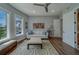 Relaxing living room with a comfy couch, geometric rug and plenty of natural light from the window at 15805 Redington Dr, Redington Beach, FL 33708