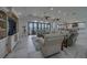 Living room featuring a large entertainment center, plush seating, and water views at 15805 Redington Dr, Redington Beach, FL 33708