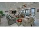 Bright living room with comfortable seating, water views, and sliding glass doors to a patio at 15805 Redington Dr, Redington Beach, FL 33708