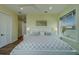 Spacious bedroom featuring light green walls, a ceiling fan and water views at 15805 Redington Dr, Redington Beach, FL 33708
