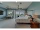 Serene main bedroom featuring a four-poster bed and stunning waterfront views from the private balcony at 15805 Redington Dr, Redington Beach, FL 33708