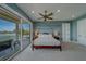 Bright main bedroom with a balcony overlooking the waterfront, creating a peaceful retreat at 15805 Redington Dr, Redington Beach, FL 33708