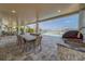 Covered outdoor dining area with an outside sink and a beautiful view of the pool and bay at 15805 Redington Dr, Redington Beach, FL 33708