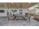 Covered outdoor seating area with comfortable furniture, overlooking the bay, is ideal for relaxing and entertaining at 15805 Redington Dr, Redington Beach, FL 33708