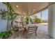 Relaxing outdoor seating offers a perfect spot to enjoy the bay view and tropical landscaping at 15805 Redington Dr, Redington Beach, FL 33708