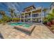 The sparkling pool and spa offer a refreshing retreat with views of the beautifully landscaped yard at 15805 Redington Dr, Redington Beach, FL 33708
