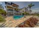 Beautiful outdoor space with a pool, patio, and lush landscaping, perfect for relaxation and enjoyment at 15805 Redington Dr, Redington Beach, FL 33708