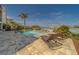 Beautiful pool with waterfront view, tropical landscaping, and sun loungers at 15805 Redington Dr, Redington Beach, FL 33708