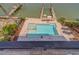 A stunning pool with a spa and sun loungers on a paved deck overlooking a private boat dock at 15805 Redington Dr, Redington Beach, FL 33708