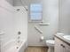 Bathroom with tiled shower, grab bars and a single vanity with storage at 16142 Amethyst Key Dr, Wimauma, FL 33598
