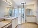 Bathroom featuring double vanity, tile flooring, bright lighting and a glass shower stall at 16142 Amethyst Key Dr, Wimauma, FL 33598