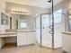 Bright bathroom featuring a glass-enclosed shower, double vanity, and tile flooring at 16142 Amethyst Key Dr, Wimauma, FL 33598