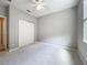 Bedroom featuring white carpet and sliding closet doors, illuminated by a ceiling fan at 16142 Amethyst Key Dr, Wimauma, FL 33598