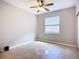 Bedroom with large window, ceiling fan, tile flooring and base molding at 16142 Amethyst Key Dr, Wimauma, FL 33598