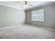 Bedroom showcases neutral color palette, carpeted floor, and natural lighting at 16142 Amethyst Key Dr, Wimauma, FL 33598