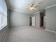 Spacious bedroom features carpeting, crown molding, a ceiling fan, and large windows at 16142 Amethyst Key Dr, Wimauma, FL 33598
