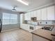 Bright kitchen featuring white cabinets, tile flooring, and neutral countertops for a modern feel at 16142 Amethyst Key Dr, Wimauma, FL 33598