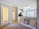Open kitchen with tile floors, stainless steel appliances, and white cabinetry at 16142 Amethyst Key Dr, Wimauma, FL 33598