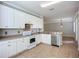 Bright kitchen featuring white cabinets, tile flooring, and neutral countertops for a modern feel at 16142 Amethyst Key Dr, Wimauma, FL 33598