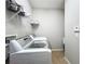 Functional laundry room features modern appliances, shelving, and neutral tones for a clean and efficient space at 16142 Amethyst Key Dr, Wimauma, FL 33598