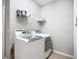 Laundry room with updated appliances and storage shelf at 16142 Amethyst Key Dr, Wimauma, FL 33598