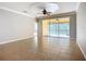 Living room featuring tile flooring and sliding glass doors to a screened-in outdoor patio at 16142 Amethyst Key Dr, Wimauma, FL 33598