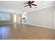 Open living room area with tile flooring, large windows, and access to kitchen area at 16142 Amethyst Key Dr, Wimauma, FL 33598