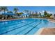 Inviting outdoor pool with blue lane markers and comfortable lounge chairs and cabanas at 16142 Amethyst Key Dr, Wimauma, FL 33598