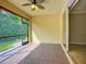 Inviting screened lanai with brick flooring and lush green views, seamlessly connects indoor and outdoor living at 16142 Amethyst Key Dr, Wimauma, FL 33598