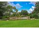 Scenic water feature with rocks, lush greenery, and a tranquil waterfall, creating a serene outdoor oasis at 16142 Amethyst Key Dr, Wimauma, FL 33598
