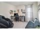 Bedroom with gaming setup, massage chair and stylish decor at 17012 Oval Rum Dr, Wimauma, FL 33598