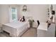 Bright, tidy bedroom with natural light and white furnishings at 17012 Oval Rum Dr, Wimauma, FL 33598