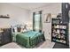 Cozy bedroom with a decorative wrought iron bed frame and bookcase at 17012 Oval Rum Dr, Wimauma, FL 33598
