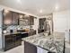Well-appointed kitchen featuring sleek cabinetry, stainless steel appliances, and granite countertops at 17012 Oval Rum Dr, Wimauma, FL 33598