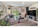 Cozy living room with natural light, comfortable seating, and backyard views at 17012 Oval Rum Dr, Wimauma, FL 33598