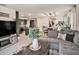Spacious living room with modern décor, leading to the kitchen and dining area at 17012 Oval Rum Dr, Wimauma, FL 33598
