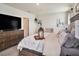 Comfortable main bedroom with a plush bed and large television at 17012 Oval Rum Dr, Wimauma, FL 33598