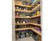 Organized pantry with custom wood shelving, perfect for storage at 17012 Oval Rum Dr, Wimauma, FL 33598