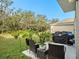 Outdoor patio featuring comfortable seating, a grill, and lush greenery in the partially fenced yard at 17012 Oval Rum Dr, Wimauma, FL 33598