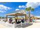 A view of the enclosed pavilion with tables and chairs by the beach at 17012 Oval Rum Dr, Wimauma, FL 33598