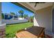 Charming backyard with a covered patio, a wooden table set and large green yard space at 1813 Hillside Dr, Tampa, FL 33610