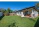 Spacious backyard featuring a well-maintained lawn, privacy fence and a covered patio for outdoor gatherings at 1813 Hillside Dr, Tampa, FL 33610