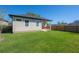 A well-manicured lawn and privacy fence encloses the backyard, creating a secluded outdoor haven at 1813 Hillside Dr, Tampa, FL 33610